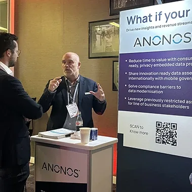 An Anonos team member presenting at a conference booth.