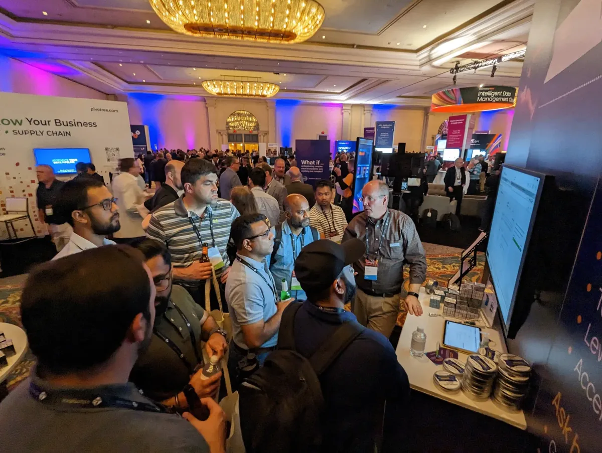 A large crowd gathered around the Anonos booth at an industry conference watching a live demo.