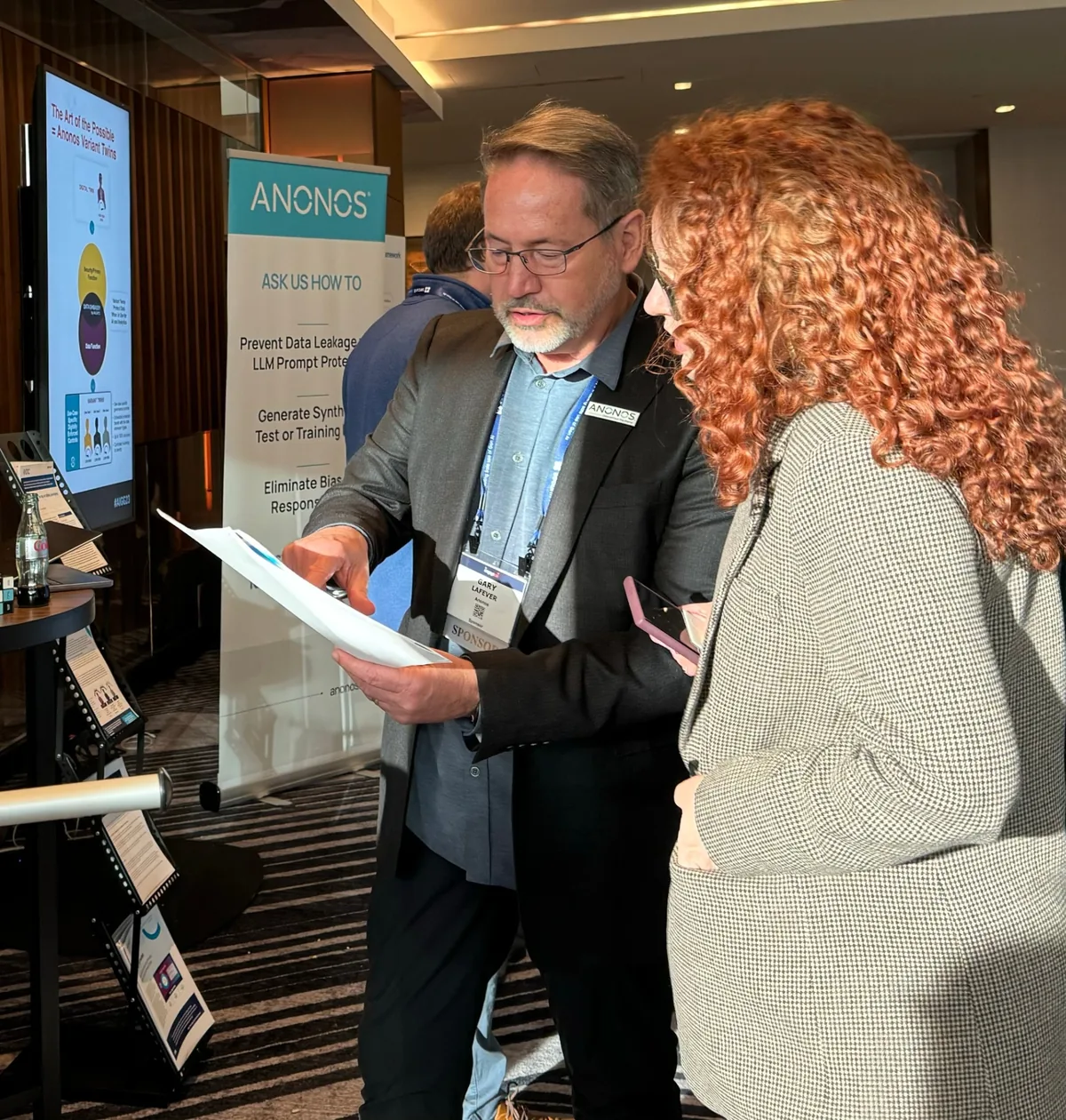 Anonos CEO Gary LaFever walking a prospect through the platform at a conference booth.